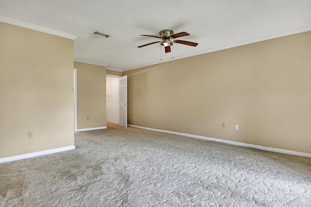 carpeted spare room with a textured ceiling, ceiling fan, and ornamental molding