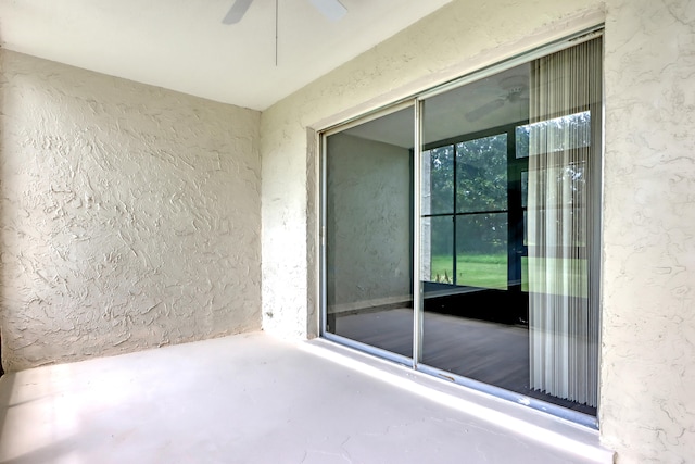 exterior space with ceiling fan and a patio area