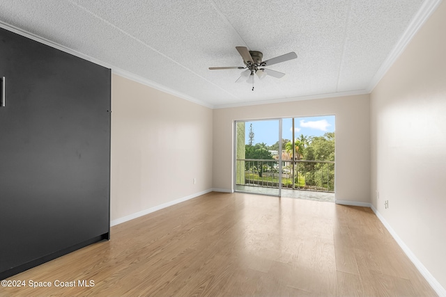 empty room featuring ceiling fan, light hardwood / wood-style floors, a textured ceiling, and ornamental molding