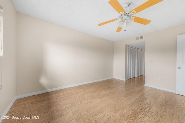 spare room with ceiling fan and light hardwood / wood-style flooring