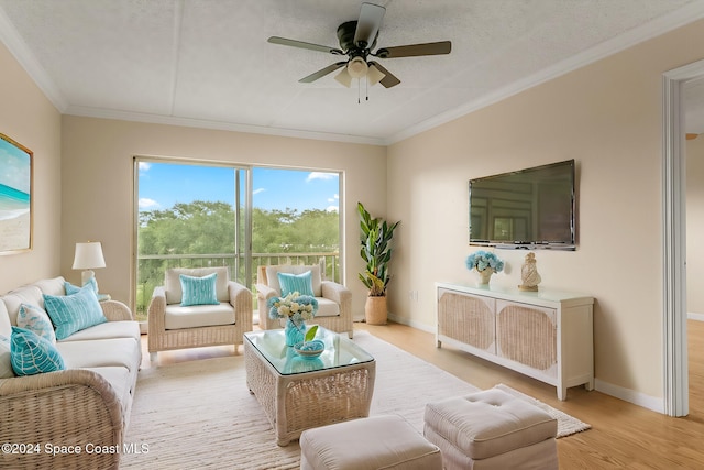 living room with a textured ceiling, ceiling fan, light wood-type flooring, and ornamental molding