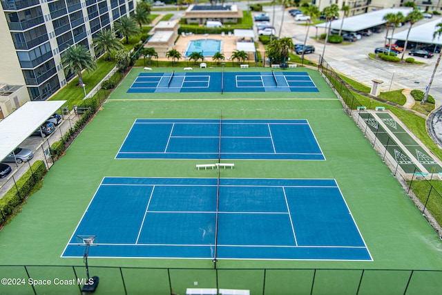 view of tennis court featuring basketball hoop