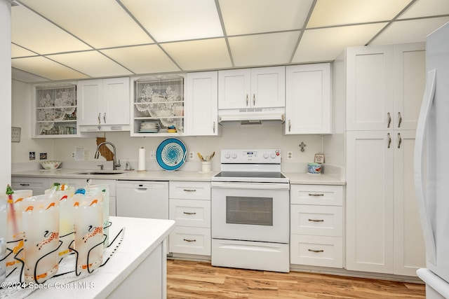 kitchen featuring white cabinetry, sink, light hardwood / wood-style floors, and white appliances