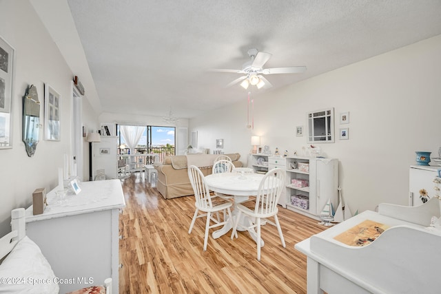 dining area featuring ceiling fan, a textured ceiling, and light wood-type flooring