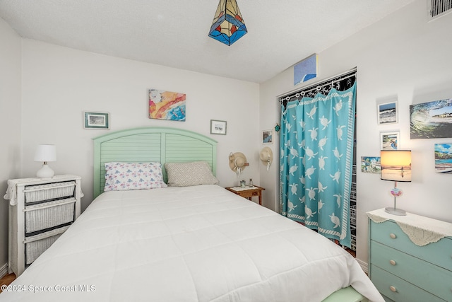 bedroom featuring a textured ceiling