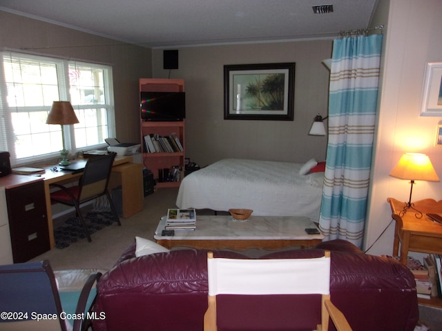 carpeted bedroom featuring crown molding