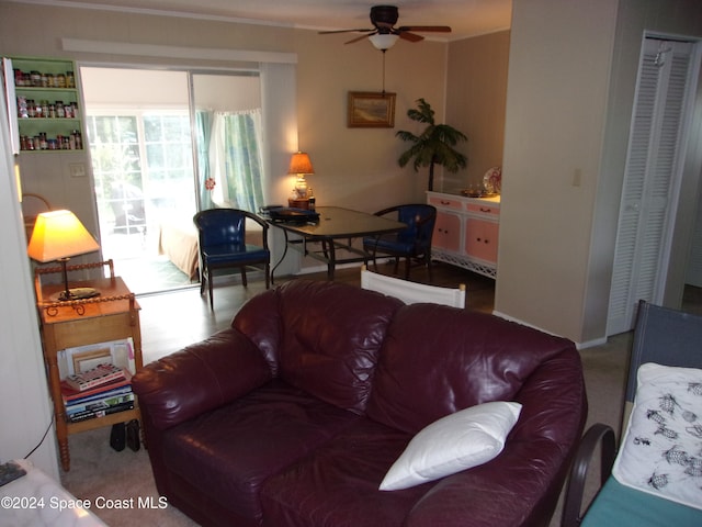 carpeted living room with ceiling fan