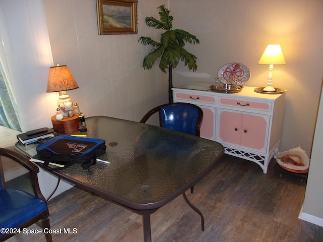 office space with hardwood / wood-style flooring and wooden walls