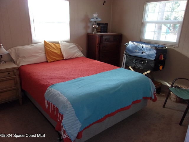 bedroom featuring dark carpet