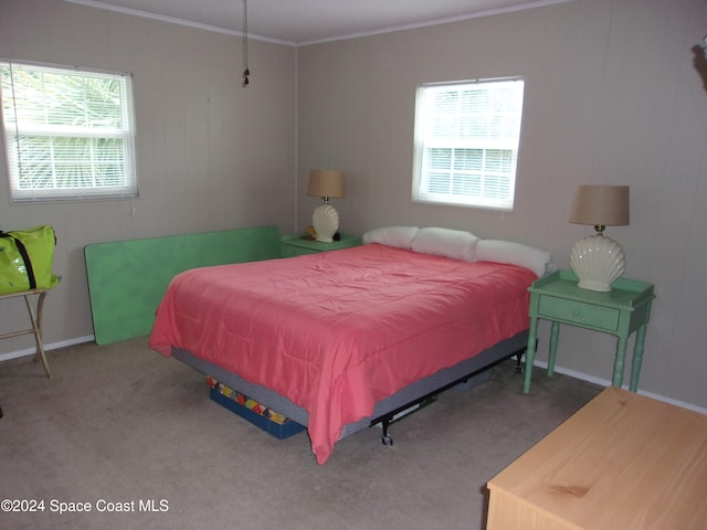 carpeted bedroom with ornamental molding