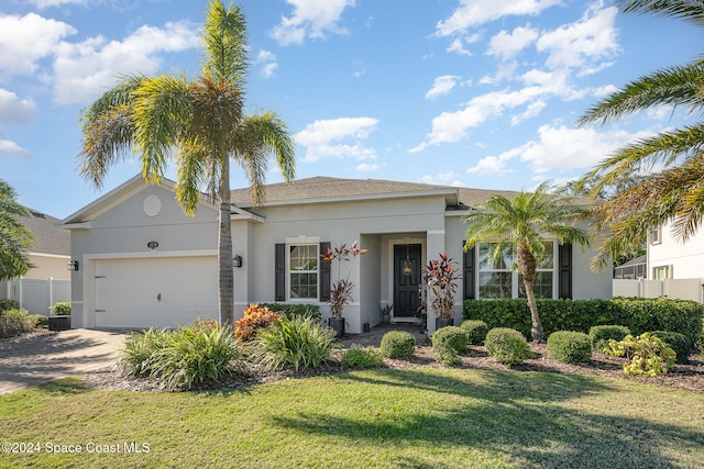 view of front of house with a garage and a front lawn