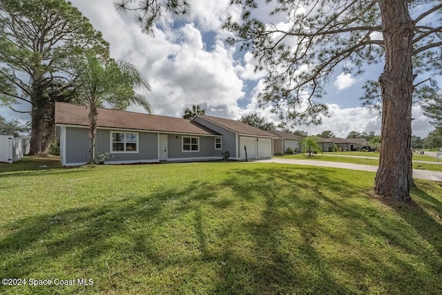 back of property featuring a garage and a yard