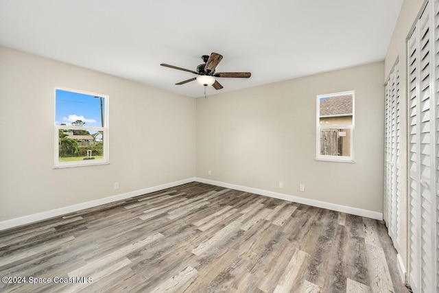 spare room featuring hardwood / wood-style floors and ceiling fan