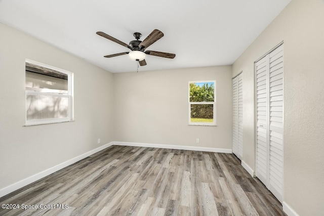 unfurnished bedroom featuring ceiling fan, light wood-type flooring, and a closet