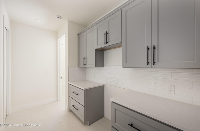 kitchen featuring gray cabinetry and backsplash