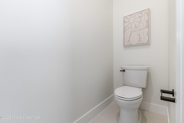 bathroom featuring tile patterned flooring and toilet