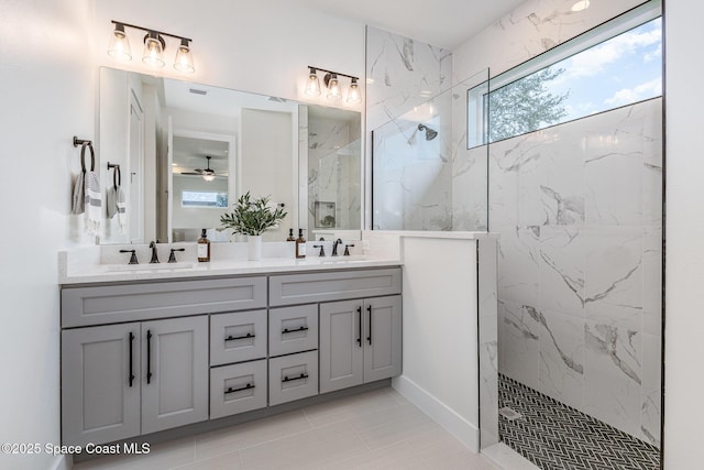 bathroom featuring vanity, ceiling fan, and tiled shower