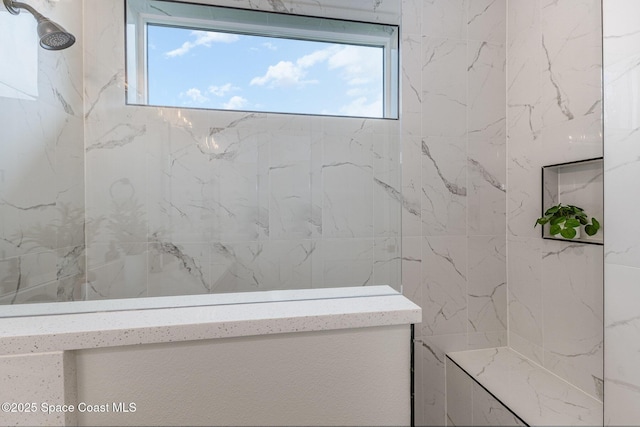 bathroom with tiled shower