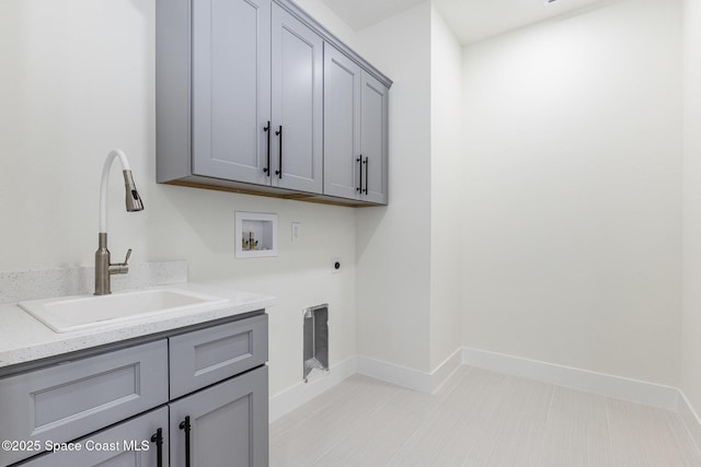 washroom featuring cabinets, washer hookup, hookup for an electric dryer, and sink