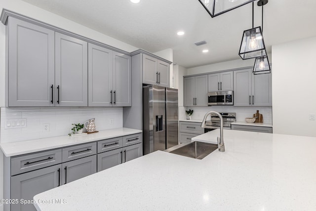 kitchen featuring stainless steel appliances and gray cabinetry