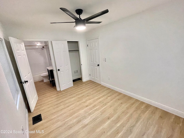 unfurnished bedroom with light hardwood / wood-style floors, ensuite bath, and ceiling fan