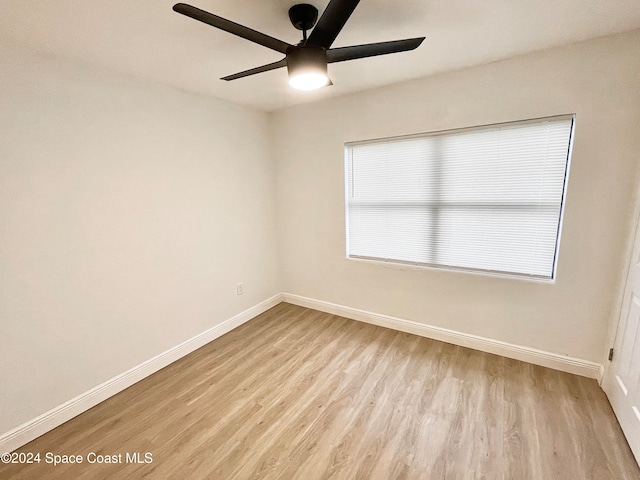 spare room featuring ceiling fan, plenty of natural light, and light wood-type flooring