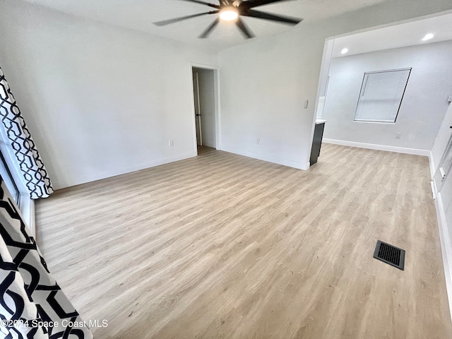 unfurnished room with ceiling fan and light hardwood / wood-style floors