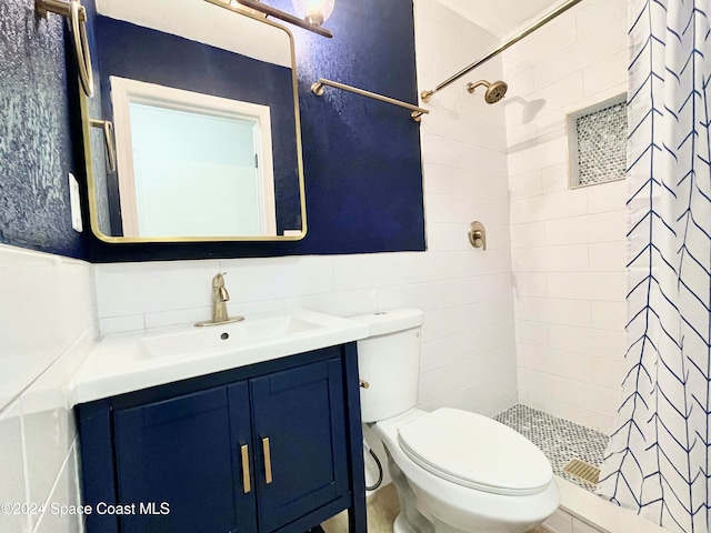 bathroom with curtained shower, vanity, and toilet