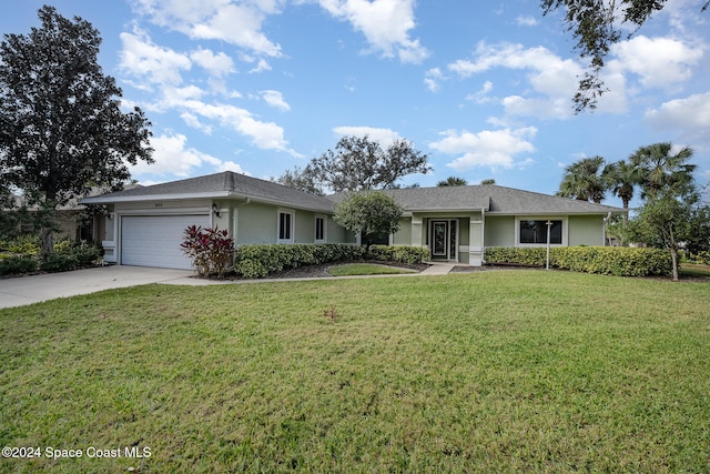 ranch-style home featuring a garage and a front yard