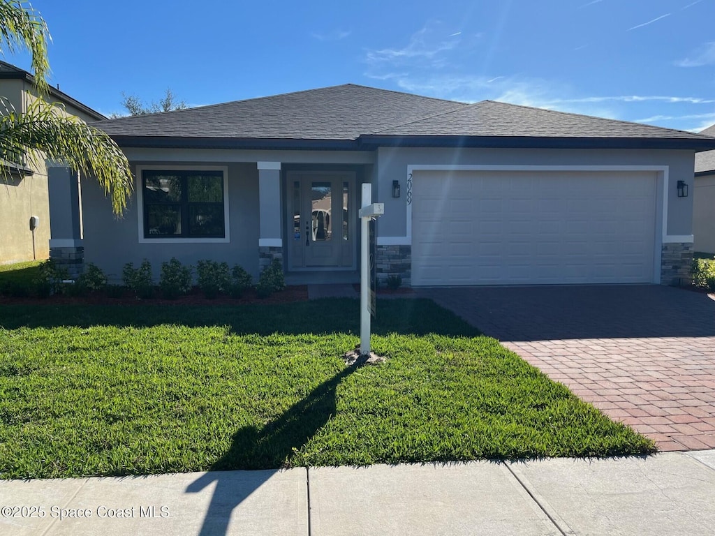 view of front of house with a front yard and a garage