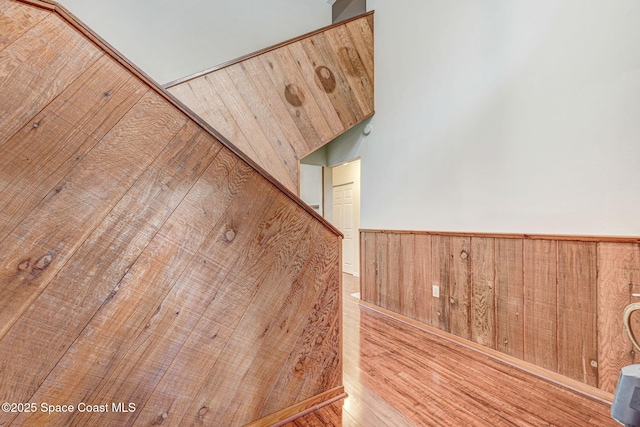 room details featuring hardwood / wood-style floors and wood walls