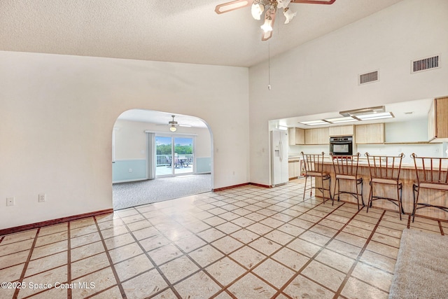 interior space featuring ceiling fan and a textured ceiling