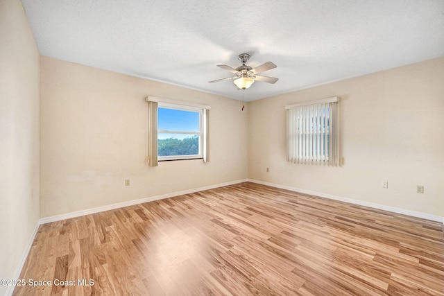 unfurnished room with light hardwood / wood-style floors, a textured ceiling, and ceiling fan