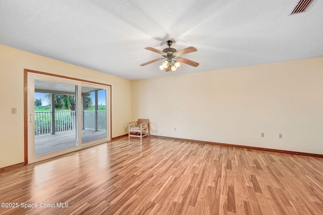 unfurnished room featuring ceiling fan, a textured ceiling, and light hardwood / wood-style floors