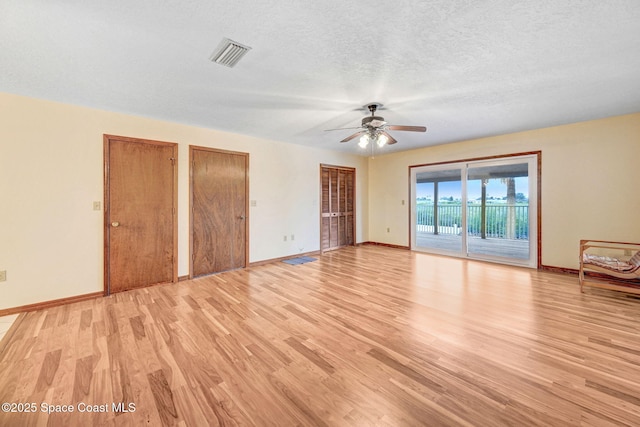 interior space featuring a textured ceiling, ceiling fan, and light hardwood / wood-style flooring