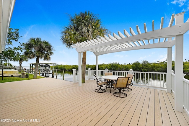 wooden terrace featuring a water view and a pergola