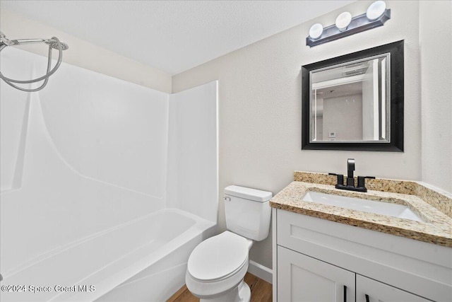 full bathroom with vanity, bathing tub / shower combination, hardwood / wood-style flooring, toilet, and a textured ceiling