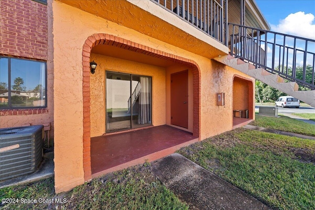 entrance to property featuring a balcony and central AC