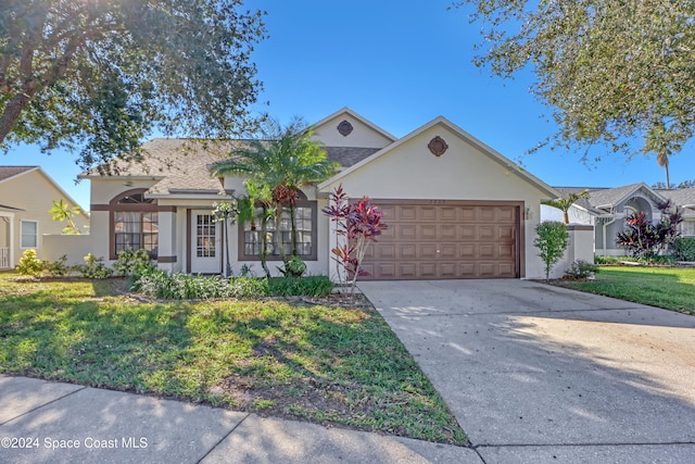 single story home with a garage and a front lawn