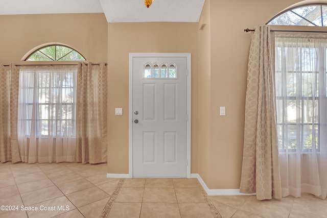 entryway featuring light tile patterned floors and a textured ceiling