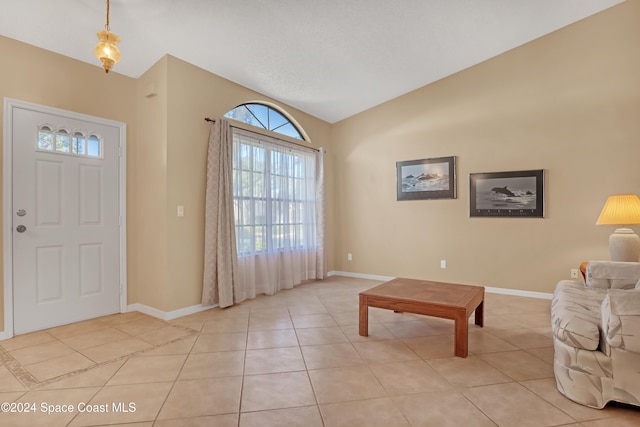 tiled entrance foyer with lofted ceiling