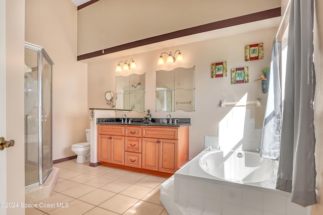 full bathroom with tile patterned flooring, vanity, separate shower and tub, and toilet