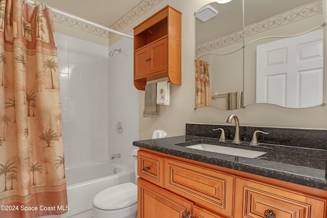 full bathroom with vanity, shower / tub combo, and toilet