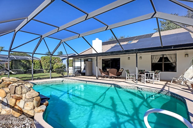 view of pool with a lanai and a patio