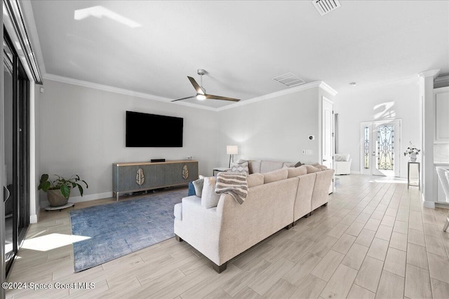 living room with ceiling fan, light hardwood / wood-style flooring, and ornamental molding