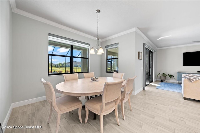 dining room with light wood-type flooring, an inviting chandelier, and ornamental molding