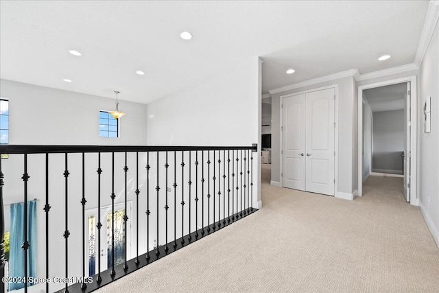 corridor featuring light carpet and ornamental molding