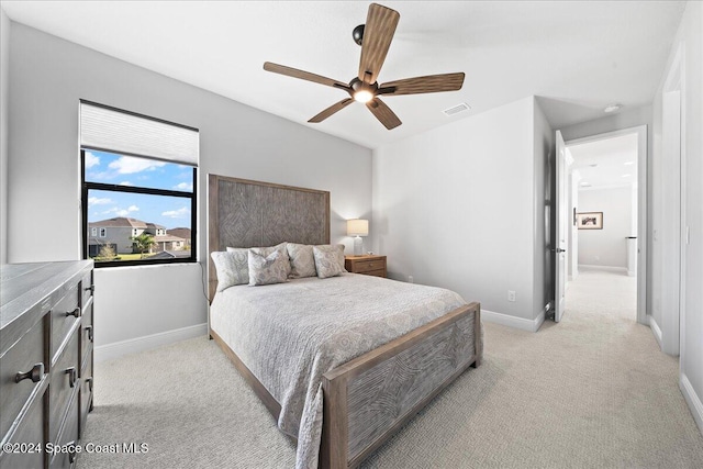 bedroom featuring ceiling fan and light colored carpet