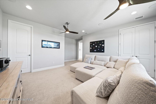 carpeted living room featuring ceiling fan