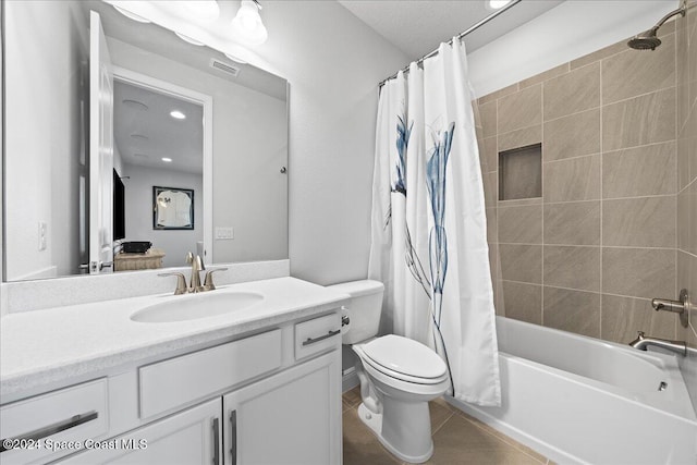 full bathroom featuring tile patterned flooring, vanity, shower / tub combo, and toilet